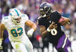  ?? MATT ROURKE AP ?? Ravens quarterbac­k Lamar Jackson (8) runs away from Dolphins defender Zach Sieler in the second half Sunday. Jackson also had a perfect passer rating of 158.3.