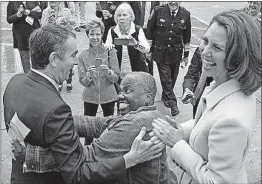  ?? ASSOCIATED PRESS] [STEVE HELBER/THE ?? Democratic Lt. Gov. Ralph Northam gets a hug form a supporter as his wife, Pam, looks on after voting in Norfolk, Virginia. Northam won the governor’s race Tuesday over Republican Ed Gillespie.