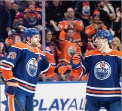  ?? CANADIAN PRESS PHOTO ?? Edmonton Oilers’ Leon Draisaitl and Evan Bouchard celebrate the game-winning goal against the Montreal Canadiens during overtime NHL action in Edmonton on Tuesday.