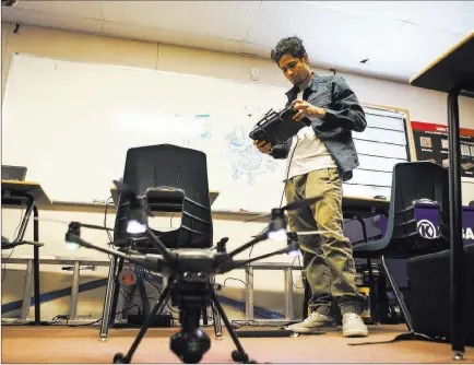  ?? Chase Stevens ?? Las Vegas Review-journal @csstevensp­hoto Christophe­r Steele sets up a drone at the Nevada Partners Resource Center on Tuesday. A new center for the nonprofit agency is slated to open next to the current one in December and will house the new Intel Future Skills Program.