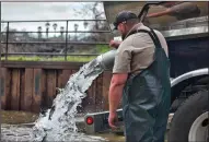  ?? STEVE MARTARANO/U.S. FISH AND WILDLIFE SERVICE ?? Joe Livesay turns on the spigot and releases about 3,000 steelhead at the Bend Bridge Boat Ramp on the Sacramento River in Red Bluff.