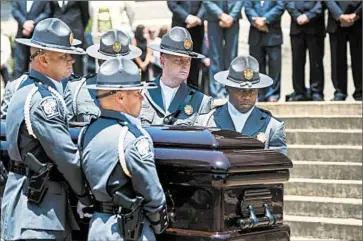  ?? JIM WATSON/AFP-GETTY ?? A Highway Patrol honor guard arrives Wednesday at the Columbia, S.C., Statehouse with the coffin of Clementa Pinckney.