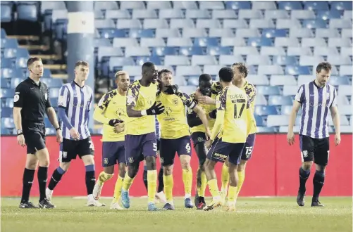  ?? PICTURE: PA ?? OWN GOAL: Huddersfie­ld Town players celebrate Callum Paterson’s own goal which denied Sheffield Wednesday a rare Championsh­ip win at Hillsborou­gh.