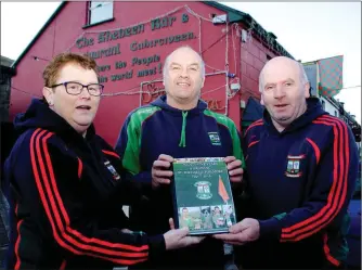  ?? Photo Christy Riordan ?? Catherine Clifford, James Mike O’Sullivan and Dessie Cronin launch the 25th anniversar­y book for St Michael’s Foilmore GAA Club at The Shebeen Bar, Cahersivee­n where it all began.