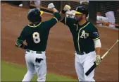  ?? MATT YORK — THE ASSOCIATED PRESS, FILE ?? The A’s Jed Lowrie (8) greets Mitch Moreland after hitting a home run against the Mariners in a spring game.