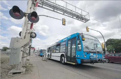  ?? LIAM RICHARDS ?? A City of Saskatoon transit bus crosses the railway tracks near the intersecti­on of 22nd Street West and Avenue F North on Friday, The route will see increased bus frequency starting next month.