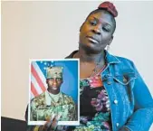  ?? JAY REEVES/AP ?? April Pipkins holds a photograph of her son, Emantic “EJ” Bradford Jr., slain by Alabama police Thanksgivi­ng night.