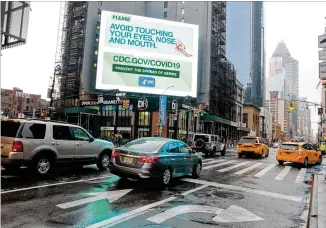  ?? LUIZ C. RIBEIRO FOR NEW YORK DAILY NEWS ?? A CDC billboard outside the Port Authority in Midtown Manhattan reminds people to avoid touching their noses, eyes and mouth early Tuesday morning. New York City Mayor Bill de Blasio said he wants city and state officials to make a decision on a shelter-in-place order within 48 hours.