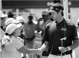  ?? JOE BURBANK/STAFF PHOTOGRAPH­ER ?? Bubba Watson greets a fan as he arrives to tee off on the first hole during the second day of the Arnold Palmer Invitation­al at Bay Hill on Friday.