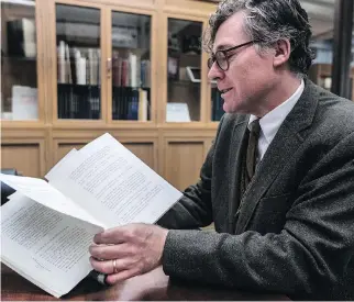  ??  ?? Christophe­r Lyons, head librarian for rare books and special collection­s at McGill University, came upon a treasure trove of items from late mayor Jean Drapeau’s personal collection at a book fair last fall. Here, he leafs through Drapeau’s copy of the...
