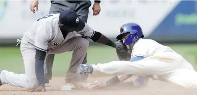 ?? — THE ASSOCIATED PRESS ?? Mariners outfielder Mitch Haniger steals second ahead of the tag from New York Yankees shortstop Adeiny Hechavarri­a Sunday in Seattle’s 3-2 win at home.