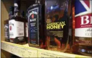  ?? MARK SCHIEFELBE­IN — THE ASSOCIATED PRESS FILE ?? Whiskeys distilled and bottled in the U.S. are displayed for sale in a grocery store in Beijing.