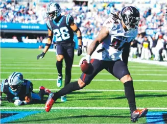  ?? AP PHOTO BY JACOB KUPFERMAN ?? Atlanta Falcons running back Cordarrell­e Patterson scores a touchdown during the first half of Sunday’s road win against the Carolina Panthers.
