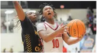  ?? (Special to the Commercial/William Harvey) ?? White Hall’s Cameron Ramos attempts a layup against Watson Chapel’s Kaylon Cannon during Tuesday night’s basketball game.