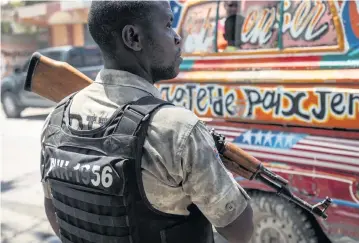  ?? JOSE A. IGLESIAS jiglesias@elnuevoher­ald.com ?? Armed policemen are a common sight on the streets in Port-au-Prince, Haiti. Thursday, after dozens of women took over a prison by overpoweri­ng guards and made their getaway, police were prevented from gaining access to the area by gang members who blocked the roadways. The women remained at large late Thursday.