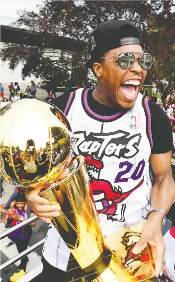  ?? FRaNK GUNN/THE CANADIAN PRESS ?? Kyle Lowry celebrates with the Larry O’Brien trophy during the Raptors’ championsh­ip parade in Toronto June 17. It was the first major title a profession­al Canadian sports team had won since 1993, when the Montreal Canadiens won the Stanley Cup, and the Toronto Blue Jays won the World Series.