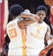  ?? / AP - Wade Payne ?? Admiral Schofield is congratula­ted by Tennessee teammate Jordan Bowden after drawing a foul during the second half of Wednesday’s game against South Carolina.
