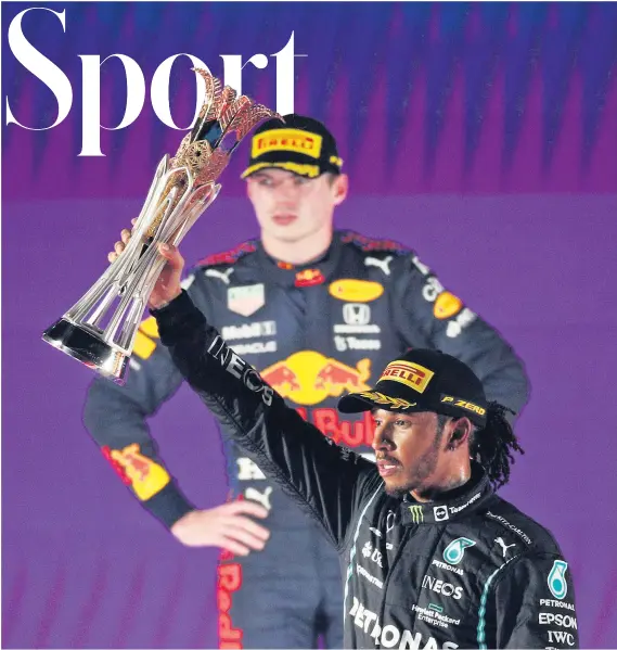  ?? ?? No love lost: Britain’s Lewis Hamilton celebrates victory in the Saudi Arabian Grand Prix last night as his rival for the driver’s championsh­ip, Red Bull’s Max Verstappen looks on