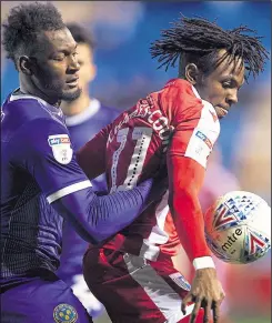  ?? Pictures: Ady Kerry ?? Gillingham’s Regan Charles-Cook is challenged by Shrewsbury’s Aaron Pierre on Tuesday night