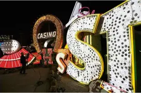  ??  ?? A videograph­er shoots a video of an exhibit at the Neon Museum in Las Vegas. Visitors will be able to see many of the city’s classic neon signs just like they were decades ago through a type of augmented reality that projects realistic animations onto...