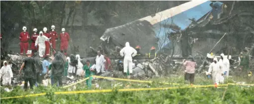  ?? RAMON ESPINOSA/ AP ?? Rescuers search through the wreckage of a Boeing 737 that crashed Friday with more than 100 passengers on board, in Havana, Cuba.