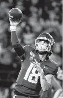  ?? Young Kwak photos / Associated Press ?? UCLA quarterbac­k Dorian Thompson-Robinson, left, threw for 507 yards and five touchdowns, including the go-ahead score, helping the Bruins overcome a school-record nine touchdown passes from Washington State’s Anthony Gordon.