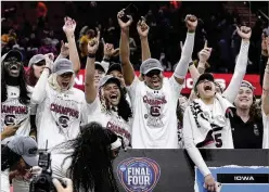  ?? MORRY GASH/AP ?? South Carolina players celebrate after beating Iowa on Sunday to win the NCAA title. The Gamecocks also finished No. 1 in the final AP poll, the first time the last poll of a season has come after the women’s tournament.