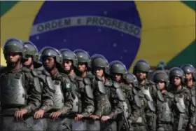  ?? ASSOCIATED PRESS FILE ?? Brazilian Army soldiers take part in military exercise during presentati­on of the security forces for the Rio 2016 Olympic Games, in front of the National Stadium, in Brasilia, Brazil. Security has emerged as the top concern during the Olympics.