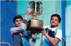  ??  ?? OXON HILL, Maryland: In this May 26, 2016 file photo, Nihar Janga, 11, of Austin, Texas, and Jairam Hathwar, 13, of Painted Post, New York, hold up the trophy after being named co-champions at the 2016 National Spelling Bee. —AP