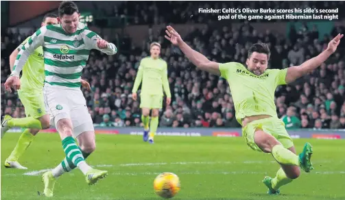  ??  ?? Finisher: Celtic’s Oliver Burke scores his side’s secondgoal of the game against Hibernian last night