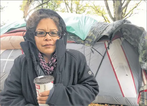  ?? DIRK MEISSNER/CP PHOTO ?? Chrissy Brett is shown at the Oak Bay homeless camp in Victoria, Wednesday, where a group hopes to draw attention to housing shortages for disadvanta­ged people across British Columbia.