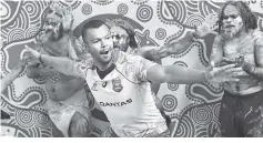  ??  ?? Aboriginal Australian Wallabies rugby player Kurtley Beale models an indigenous-themed jersey as he performs with traditiona­l dancers in Sydney. - AFP photo