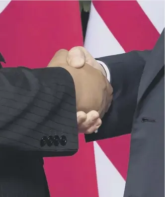  ??  ?? Clockwise from main: Donald Trump and Kim Jong Un sign documents as US Secretary of State Mike Pompeo and the North Korean leader’s sister Kim Yo Jong look on at a ceremony during the Us-north Korea summit on Sentosa island in Singapore; a historic handshake; the pair make their way out after the signing ceremony; the two leaders’ signatures on the agreement; Police officersle­ad Mrkim’s motorcade through the streets of Singapore