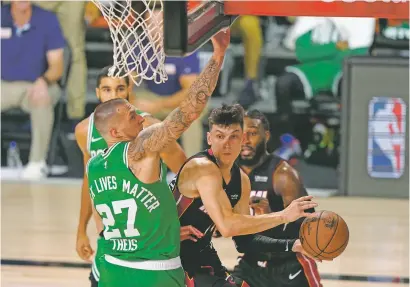  ?? MARK J. TERRILL/ASSOCIATED PRESS ?? The Heat’s Tyler Herro, right, scored a team rookie-record 37 points on Wednesday in Lake Buena Vista, Fla., as Miami defeated the Celtics and is one win away from the NBA Finals.