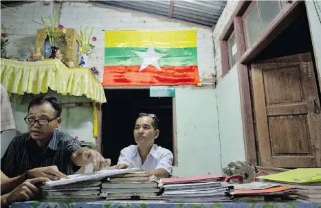  ?? GEMUNU AMARASINGH­E/THE ASSOCIATED PRESS ?? Administra­tive officers in Dala, a suburb of Yangon. In Myanmar, a nearly century-old law empowers the state to decide what guests, if any, a family may have in their own home, illustrati­ng just how much power the military retains despite the country’s...