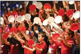  ?? NWA Democrat-Gazette/FLIP PUTTHOFF ?? Westside second-graders sing a patriotic song Friday during the school’s Veterans Day program at the Rogers school. Students performed songs and heard video remarks from veterans. Today is Veterans Day.