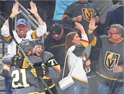  ?? STEPHEN R. SYLVANIE/USA TODAY SPORTS ?? Center William Karlsson (71) is embraced by Cody Eakin after scoring, and the Golden Knights have been embraced by NHL fans in Las Vegas in their expansion season.