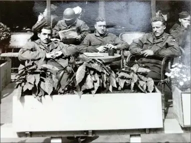  ?? CONTRIBUTE­D PHOTO ?? This group photo is from World War II and was taken in 1945 at a sidewalk cafe in Paris. Wilson (right) is pictured with some of his fellow service men, Charles Nicholas and Clarence Weddle.