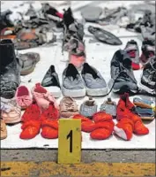  ?? Bay Ismoyo AFP/Getty Images ?? AN INDONESIAN safety committee report said the Lion Air 737 Max’s f light-control system had had multiple failures on previous f lights and hadn’t been properly repaired. Above, the shoes of crash victims.