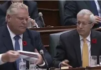  ?? ONTARIO LEGISLATUR­E ?? Premier Doug Ford receives books by Star reporter Tanya Talaga before passing them to Finance Minister Vic Fedeli.