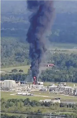  ?? AP PHOTO ?? HOT SPOT: Flames can be seen inside a towering column of black smoke at the Arkema chemical plant in Crosby, Texas, yesterday.