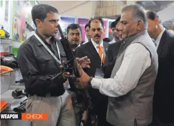  ?? — BIPLAB BANERJEE ?? Union minister of state V. K. Singh inspects a weapon at the inaugural function of the India Internatio­nal Security Expo 2015 at Pragati Maidan in New Delhi on Thursday.