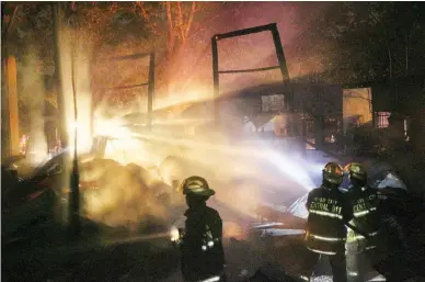  ??  ?? US-ERA GABALDON BUILDING – Firefighte­rs try to put out the fire engulfing the F. Bustamante Elementary School in Barangay Tibungco, Davao City, which was built in the 1930s during the American colonial period, and is now considered an ‘Important...