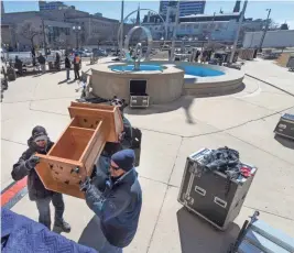  ?? MARK HOFFMAN / MILWAUKEE JOURNAL SENTINEL ?? Workers move a podium into place on the south side the Milwaukee County Courthouse in advance of the March for Our Lives on Saturday. The march will start at the courthouse and end downtown at Red Arrow Park. The march is one of scores anticipate­d...