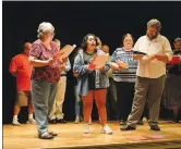  ?? NWA Democrat-Gazette/ANDY SHUPE ?? Katherine Shurlds (from left), Andrea Elvir Galvez and Ray Minor rehearse for this year’s Northwest Arkansas Gridiron Show.