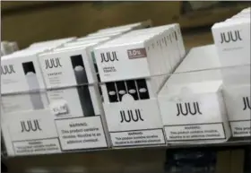  ?? SETH WENIG, FILE — THE ASSOCIATED PRESS ?? This Thursday, Dec. 20, 2018, file photo shows Juul products for sale. North Carolina’s attorney general has filed a lawsuit against the popular e-cigarette maker JUUL, asking a court to limit what flavors it can sell and ensure underage teens can’t buy it.
