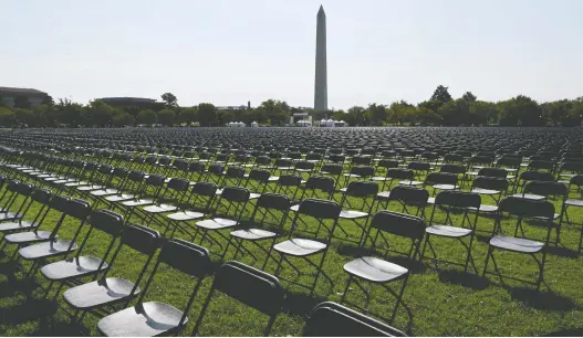  ?? KATHERINE FREY/ WASHINGTON POST ?? People who lost family in the COVID-19 pandemic placed thousands of chairs, each representi­ng 10 deaths, near the White House in October to honour the dead. As deaths mount, they grow harder to fathom, psychologi­sts say. Catastroph­es like hurricane Katrina and 9/11 had widely viewed images of the disasters and their impacts.