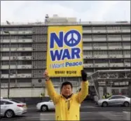  ?? AHN YOUNG-JOON — THE ASSOCIATED PRESS ?? A protester holds up a banner to oppose the United States’ policies against North Korea near the U.S. Embassy in Seoul, South Korea, Friday.