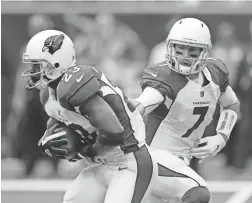  ?? AP ?? Cardinals quarterbac­k Blaine Gabbert (7) hands off to running back Adrian Peterson during last Sunday’s game against the Texans in Houston.