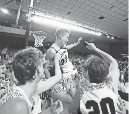  ?? PATRICK BREEN/THE REPUBLIC ?? Gilbert Highland players lift senior Hayden Winegar after he hit a game-winning 3-pointer against Phoenix Brophy in the closing seconds of the second overtime in the 6A championsh­ip game on Saturday.